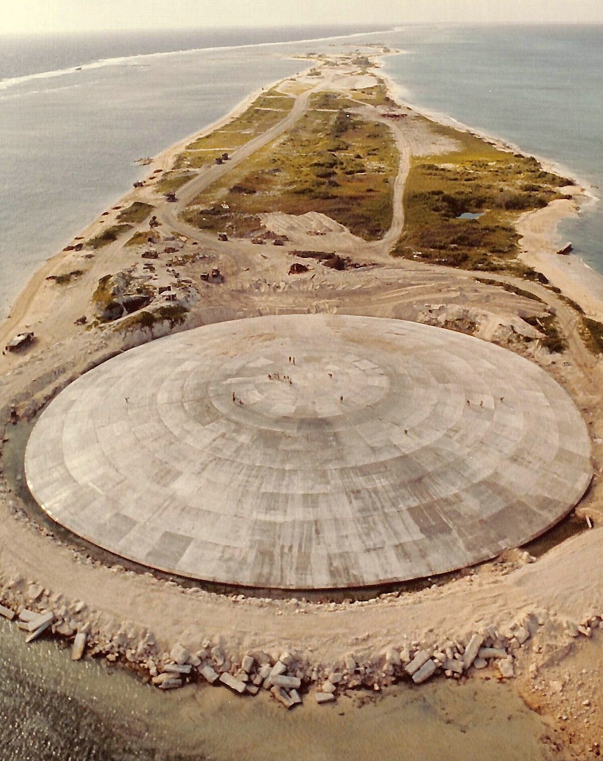 Runit Dome (or Cactus Dome), Runit Island, Enewetak Atoll. Aerial view. In 1977-1980 the crater created by the Cactus shot of Operation Hardtack I was used as a burial pit to inter 84,000 cubic meters of radioactive soil scraped from the various contaminated Enewetak Atoll islands. The Runit Dome was built to cover the material.